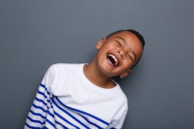 Boy in a white jumper laughing